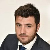 A person wearing a suit and tie Description generated with very high confidence